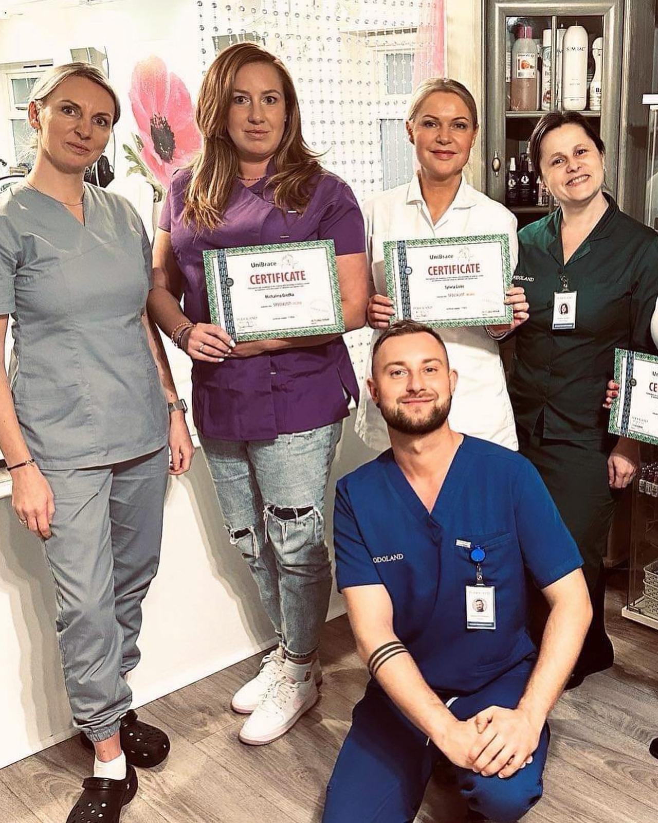 Michelle with UniBrace certificate alongside colleagues