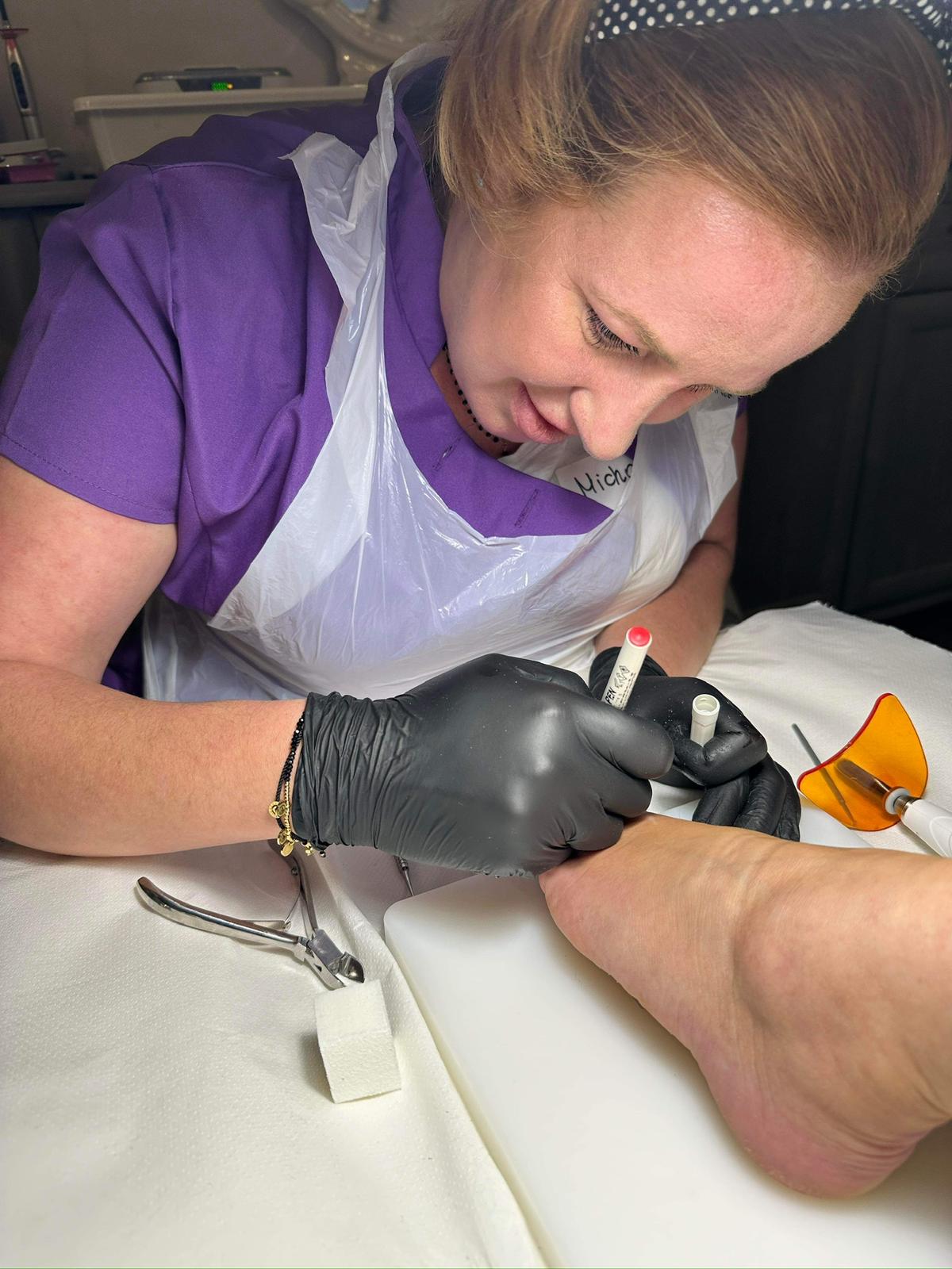 Precise nail treatment under magnifying lamp